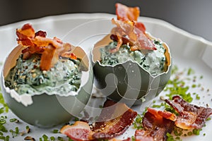 eggshell containing spinach foam and crispy bacon