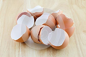 Eggshells on wooden table photo