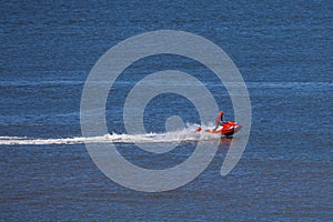 Members of the dutch coastguard `Reddingsbrigade` on a jet ski during a lifesaving drill