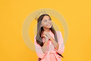 egocentric happy teen girl in home terry bathrobe and queen crown, egoism photo