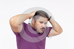 A egotistical man posing trying to look cool and sexy, but looking very awkward and cringe instead. Wearing a purple waffle shirt