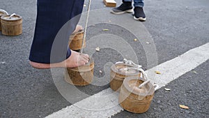 Egrang shell is a game of stilts that use coconut shells or bamboo as a foohold. photo
