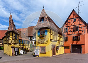 Historic colorful half-timbered houses and wine cellars in the village center of Eguisheim
