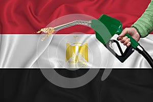 EGYPT flag Close-up shot on waving background texture with Fuel pump nozzle in hand. The concept of design solutions. 3d rendering