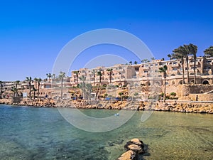 Egypt, Hurghada- AUGUST 28th 2020 Crystal clear azure water - resort with white beach - paradise coastline, beautiful buildings