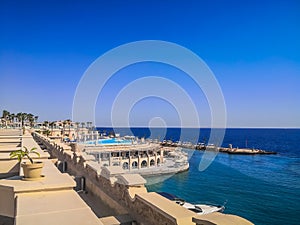 Egypt, Hurghada- AUGUST 28th 2020 Crystal clear azure water - resort with white beach - paradise coastline, beautiful buildings