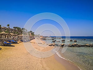 Egypt, Hurghada- AUGUST 28th 2020 Crystal clear azure water - resort with white beach - paradise coastline, beautiful buildings