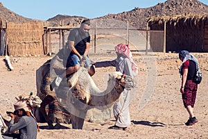 Egypt, Hurghada, 12 may 2019, beduins and tourits ride a camels in the desert