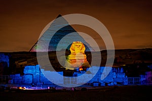 Egypt night at the Pyramids with the Sphinx illuminated photo