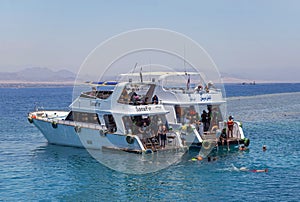 Egypt, Sharm el Sheikh - July 23, 2021. A white ship, people are snorkeling in the red sea. Tiran island