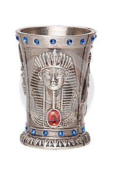 Egyptian art. Close-up of egyptian metalic cup with gems isolated on a white background. Egypt souvenir. Macro