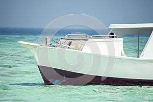 Egyptian beach with rock island and boat at Red sea