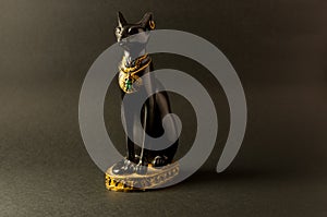 Egyptian black bastet cat figurine on black background