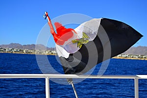 Egyptian flag on the background of the Red Sea. Flag of Egypt on background of sea and Tiran island