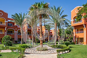 Egyptian garden with palm trees in hotel Caribbean World Resort Soma Bay
