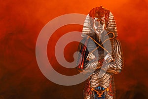 egyptian golden pharaoh statue in red smoke