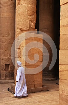 Egyptian man walking by the column, Philae Temple