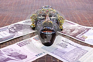 Egyptian mask lies at Egyptian pounds.