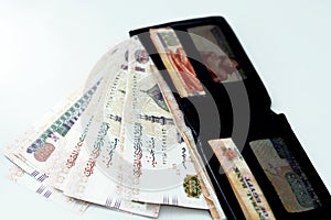 Egyptian money banknote inside a black wallet  on a black background, 200 LE two hundred Egyptian pounds bills