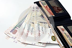 Egyptian money banknote inside a black wallet isolated on a black background, 200 LE two hundred Egyptian pounds bills