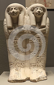 Egyptian statutes displayed on a gray background