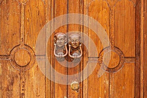 Egyptian styled knockers on wooden doors in the medieval hilltop town of Caronia