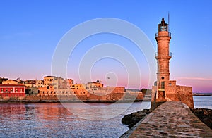 Egyptian or Venetian Lighthouse of Old Venetian harbour of Chania, Crete, Greece at sunrise. Soft sky colors from blue