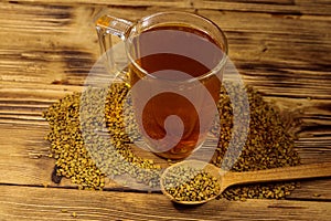 Egyptian yellow tea or Methi Dana drink and fenugreek seeds on wooden table