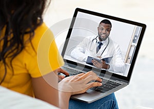 Ehealth. Unrecognizable woman having online video conference with doctor on webcam, using laptop to chat with GP