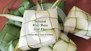 Eid Mubarak celebration card translate in Bahasa Indonesia or Malay language - Selamat Hari Raya Idul Fitri. Ketupat background.