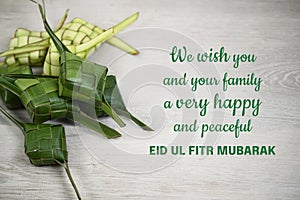 Eid Mubarak love wishes - We wish you and your family very happy and peaceful Eid Ul Fitr Mubarak. With ketupat rice dumpling.