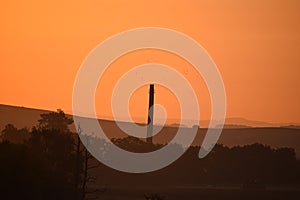 round 19th century chimney in sunrise