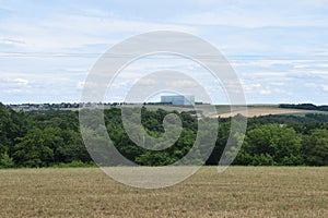 Eifel landscape with a huge logistics building like a fallen down dice