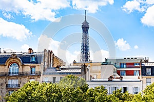 Eifel tower over the buildings in Paris downtown