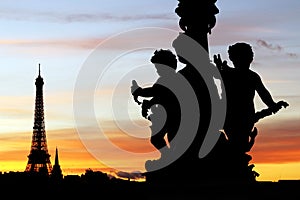 Eiffel tower and Alexandre III bridge sculptures silhouettes during a Parisian sunset