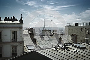 Eiffel tower behind roofs