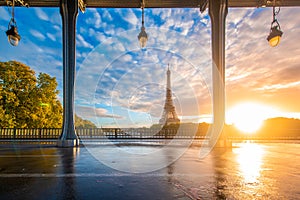 Eiffel Tower and Bir Hakeim Bridge in Paris, France during sunrise.