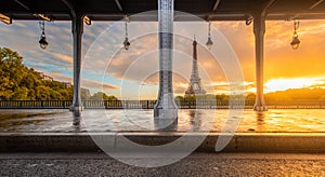 Eiffel Tower and Bir Hakeim Bridge in Paris, France during sunrise.