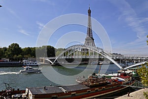 Eiffel Tower & blue sky with clouds, Paris, France - view from water with arched bridge over River Seine - JULY 24, 2015