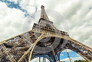 Eiffel Tower bottom view, Paris, France. Photo of openwork construction on sky background