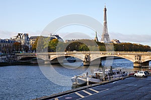 Eiffel tower and bridge with Seine river view and riverside in a sunny autumn day in Paris, France