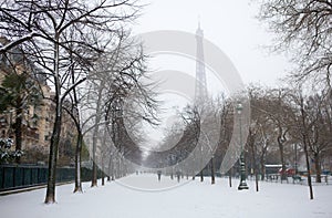 Eiffel tower and Champ de Mars covered with sno