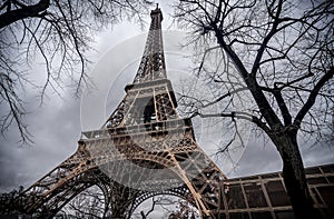 The Eiffel Tower with gray sky and clouds in Paris, France