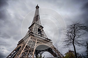 The Eiffel Tower with gray sky and clouds in Paris, France