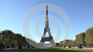 Eiffel tower and green alley, blue serene sky, beautiful romantic french day