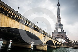 Eiffel tower and Jena bridge in a cloudy day