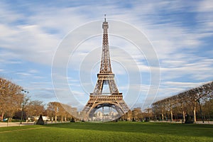 Eiffel tower with moving clouds on blue sky in Paris