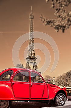 Eiffel Tower with old red car in Paris, France