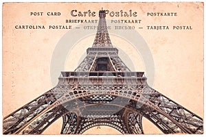 Eiffel tower in Paris, France, collage on sepia vintage postcard background, word postcard in several languages