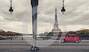 Eiffel Tower, Paris, France and retro red car under the Pont de Bir-Hakeim Bridge